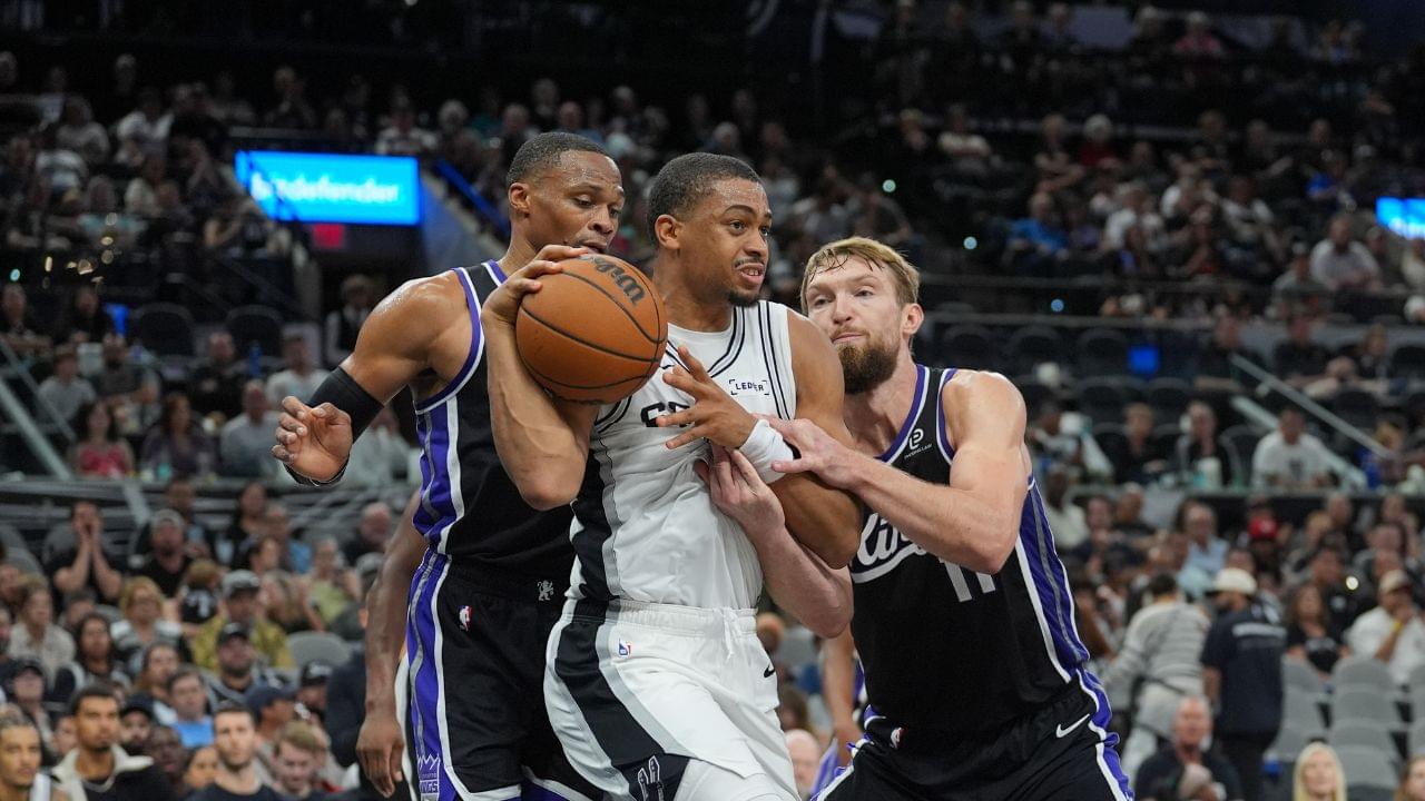 San Antonio Spurs forward Keldon Johnson (3) grabs a rebound in between Sacramento Kings guard Russell Westbrook (18) and forward Domantas Sabonis (11) in the second half at Frost Bank Center.