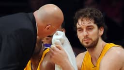 Feb. 3, 2011; Los Angeles, CA, USA; Los Angeles Lakers power forward Pau Gasol (16) sits on the bench as trainer Gary Vitti attends to him after getting an elbow in the eye during the 4th quarter of the game at the Staples Center