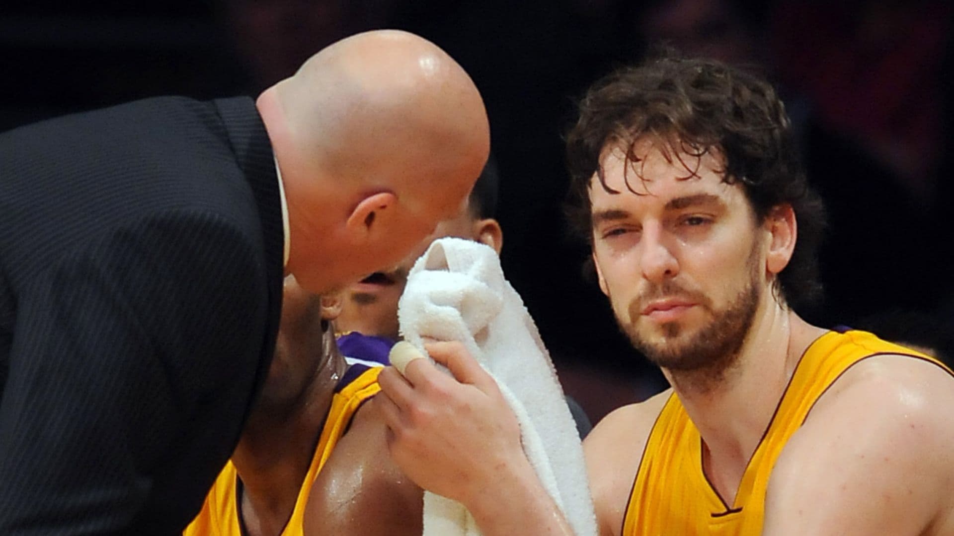 Feb. 3, 2011; Los Angeles, CA, USA; Los Angeles Lakers power forward Pau Gasol (16) sits on the bench as trainer Gary Vitti attends to him after getting an elbow in the eye during the 4th quarter of the game at the Staples Center