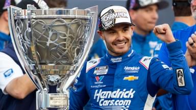 Nov 2, 2025; Avondale, Arizona, USA; NASCAR Cup Series driver Kyle Larson (5) celebrates with the Bill France Cup trophy after clinching the 2025 NASCAR Cup Series Championship following the NASCAR Championship race at Phoenix Raceway.