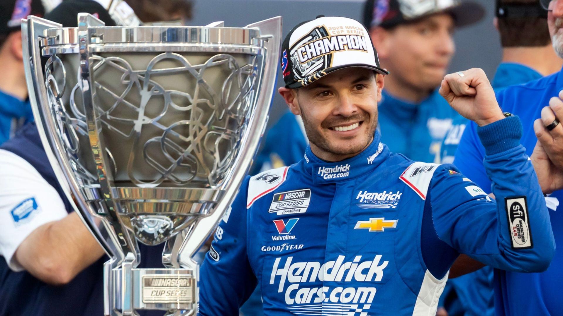 Nov 2, 2025; Avondale, Arizona, USA; NASCAR Cup Series driver Kyle Larson (5) celebrates with the Bill France Cup trophy after clinching the 2025 NASCAR Cup Series Championship following the NASCAR Championship race at Phoenix Raceway.