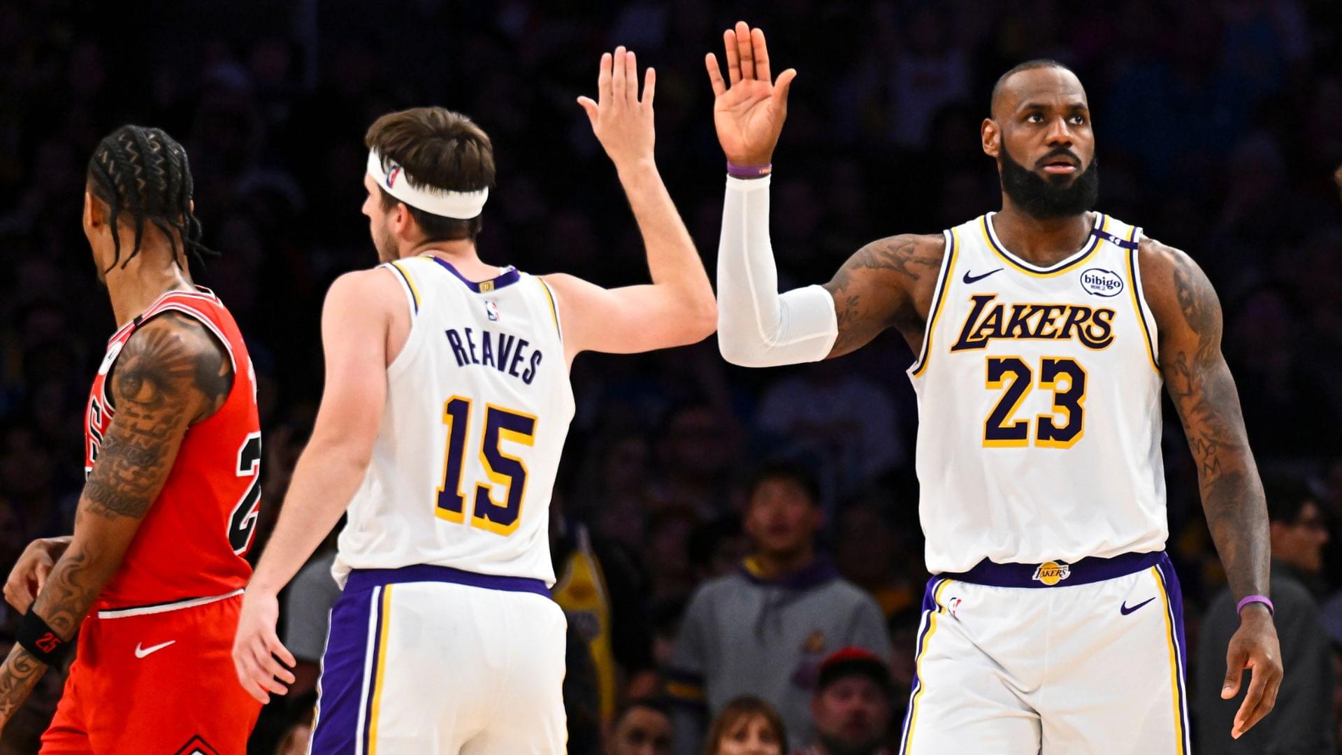 Mar 22, 2025; Los Angeles, California, USA; Los Angeles Lakers forward LeBron James (23) fives guard Austin Reaves (15) after scoring against the Chicago Bulls during the second half at Crypto.com Arena.