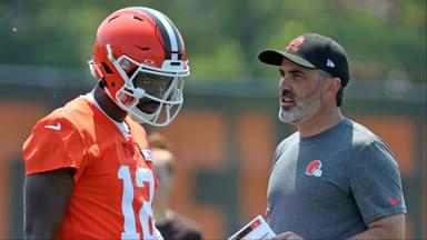 Cleveland Browns quarterback Shedeur Sanders speaks with coach Kevin Stefanski during practice at minicamp June 11, 2025, in Berea, Ohio.