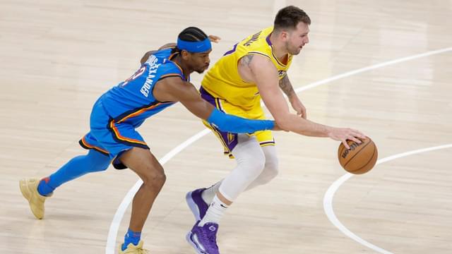 Oklahoma City Thunder guard Shai Gilgeous-Alexander (2) reaches to steal the ball from Los Angeles Lakers guard Luka Doncic (77) during the second half at Paycom Center.
