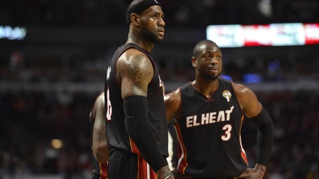 Miami Heat forward LeBron James (L) and guard Dwyane Wade stand on the court during the third quarter against the Chicago Bulls at the United Center in Chicago on March 27, 2013