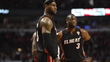 Miami Heat forward LeBron James (L) and guard Dwyane Wade stand on the court during the third quarter against the Chicago Bulls at the United Center in Chicago on March 27, 2013