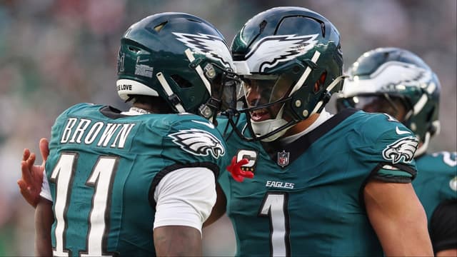 Philadelphia Eagles quarterback Jalen Hurts (1) and wide receiver A.J. Brown (11) celebrate after a touchdown against the Washington Commanders during the first half in the NFC Championship game at Lincoln Financial Field.