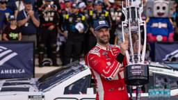 Oct 5, 2025; Concord, North Carolina, USA; NASCAR Cup Series driver Shane van Gisbergen (88) raises the Roval trophy in victory lane at Charlotte Motor Speedway Road Course.