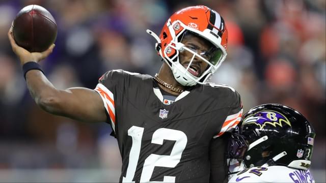 Cleveland Browns quarterback Shedeur Sanders (12) is hit by Baltimore Ravens linebacker Trenton Simpson (32) during the second half of an NFL football game at Huntington Bank Field, Nov. 16, 2025, in Cleveland, Ohio.
