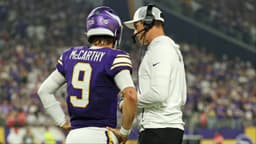 Minnesota Vikings quarterback J.J. McCarthy (9) speaks with Minnesota Vikings head coach Kevin O'Connell during the first half against the Atlanta Falcons at U.S. Bank Stadium.