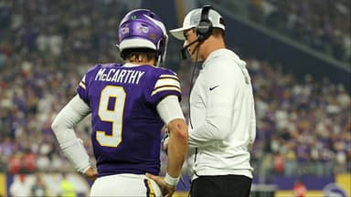 Minnesota Vikings quarterback J.J. McCarthy (9) speaks with Minnesota Vikings head coach Kevin O'Connell during the first half against the Atlanta Falcons at U.S. Bank Stadium.