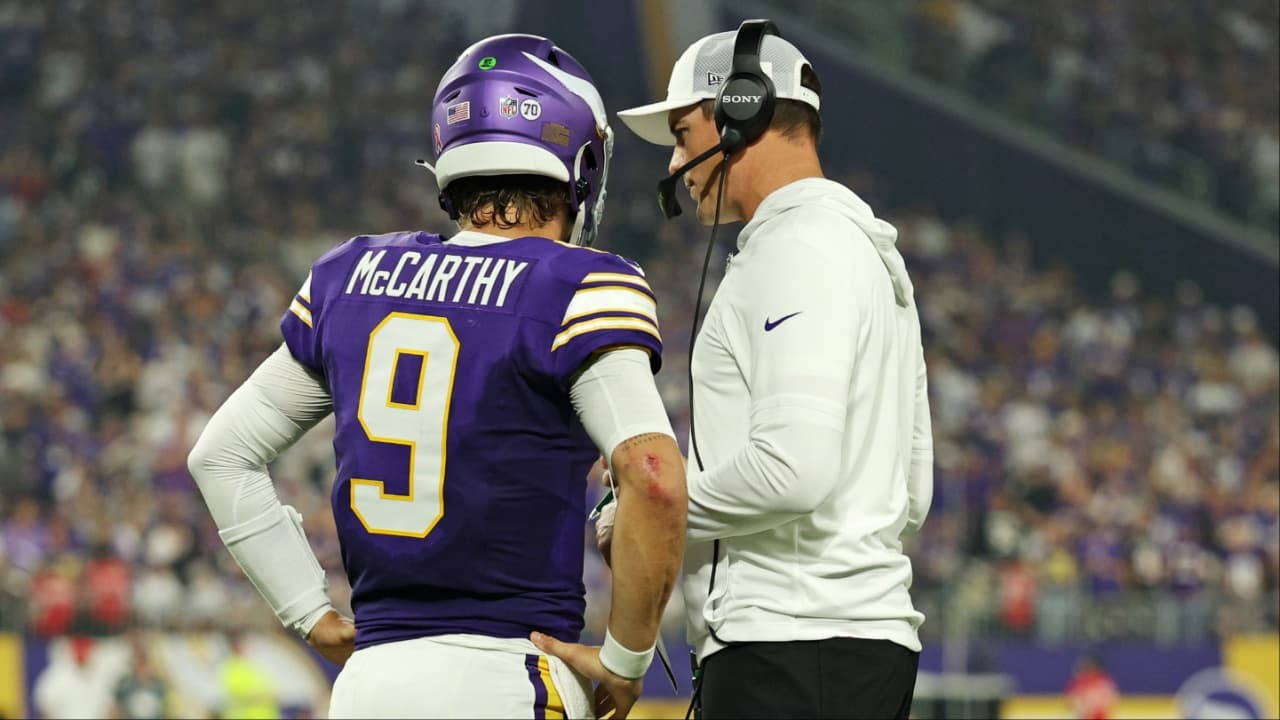 Minnesota Vikings quarterback J.J. McCarthy (9) speaks with Minnesota Vikings head coach Kevin O'Connell during the first half against the Atlanta Falcons at U.S. Bank Stadium.