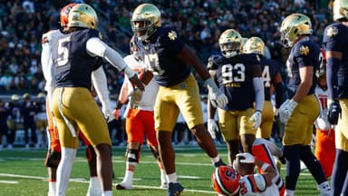 Notre Dame defensive lineman Jason Onye (47) celebrates tackling Syracuse running back Will Nixon (24) in the first half of a NCAA football game at Notre Dame Stadium on Saturday, Nov. 22, 2025, in South Bend.