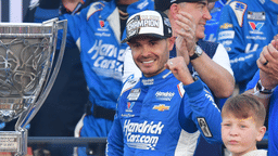 Nov 2, 2025; Avondale, Arizona, USA; NASCAR Cup Series driver Kyle Larson (5) celebrates his championship victory following the Cup Series Championship race with son Owen at Phoenix Raceway. Mandatory Credit: Gary A. Vasquez-Imagn Images