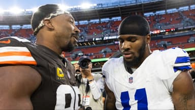 Cleveland Browns defensive end Myles Garrett (95) congratulates Dallas Cowboys linebacker Micah Parsons (11) after the game at Huntington Bank Field.