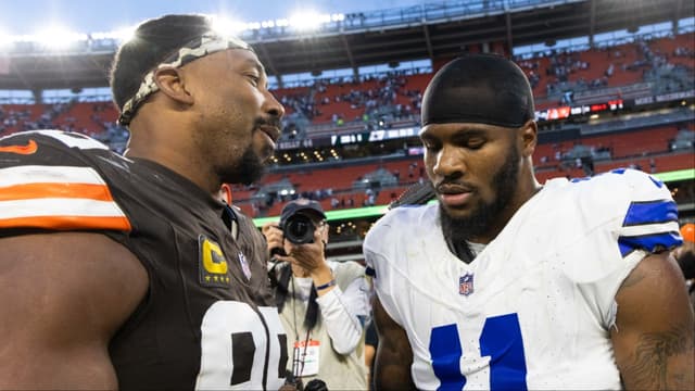 Cleveland Browns defensive end Myles Garrett (95) congratulates Dallas Cowboys linebacker Micah Parsons (11) after the game at Huntington Bank Field.