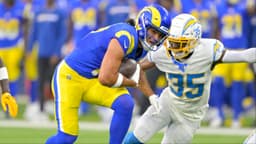 Los Angeles Rams wide receiver Puka Nacua (17) hangs on the the ball before he is stopped by Los Angeles Chargers cornerback AJ Uzodinma (35) in the first half at SoFi Stadium.
