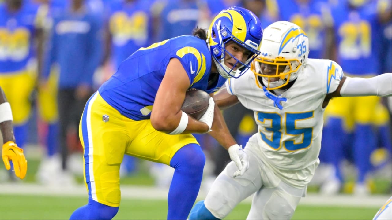 Los Angeles Rams wide receiver Puka Nacua (17) hangs on the the ball before he is stopped by Los Angeles Chargers cornerback AJ Uzodinma (35) in the first half at SoFi Stadium.