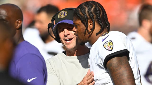 Baltimore Ravens head coach John Harbaugh talks with quarterback Lamar Jackson (8) in the fourth quarter against the Cleveland Browns at Cleveland Browns Stadium.