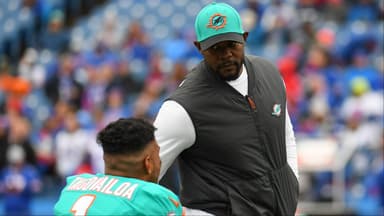 Miami Dolphins head coach Brian Flores greets quarterback Tua Tagovailoa (1) prior to the game against the Buffalo Bills at Highmark Stadium.