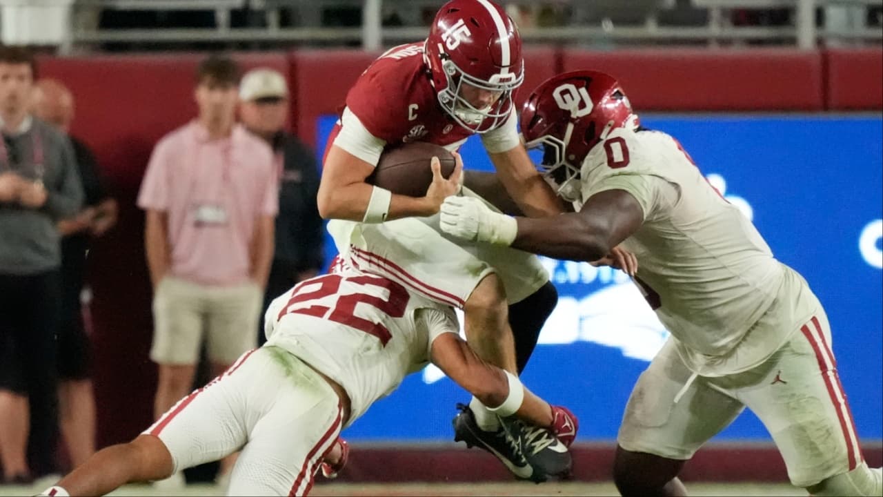 Nov 15, 2025; Tuscaloosa, Alabama, USA; Oklahoma Sooners defensive back Peyton Bowen (22) and defensive lineman David Stone (0) combine to tackle Alabama Crimson Tide quarterback Ty Simpson (15) at Saban Field at Bryant-Denny Stadium. Oklahoma defeated Alabama 23-21.