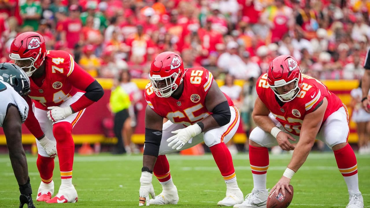 Kansas City Chiefs offensive tackle Jawaan Taylor (74) and guard Trey Smith (65) and center Creed Humphrey (52) at the line of scrimmage against the Philadelphia Eagles during the game at GEHA Field at Arrowhead Stadium.