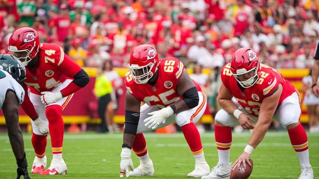 Kansas City Chiefs offensive tackle Jawaan Taylor (74) and guard Trey Smith (65) and center Creed Humphrey (52) at the line of scrimmage against the Philadelphia Eagles during the game at GEHA Field at Arrowhead Stadium.
