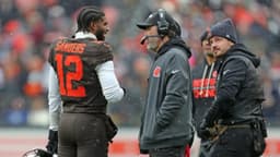 Cleveland Browns quarterback Shedeur Sanders (12) talks with coach Kevin Stefanski during a game against the Tennessee Titans on Dec. 7, 2025, in Cleveland.