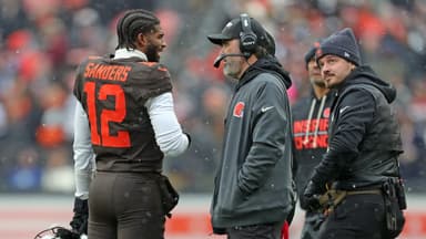 Cleveland Browns quarterback Shedeur Sanders (12) talks with coach Kevin Stefanski during a game against the Tennessee Titans on Dec. 7, 2025, in Cleveland.