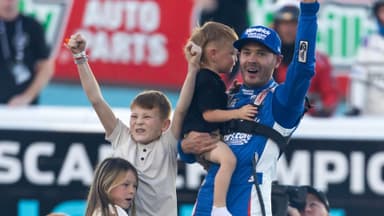 Nov 2, 2025; Avondale, Arizona, USA; NASCAR Cup Series driver Kyle Larson (5) celebrates with children Owen Larson, Audrey Larson and Cooper Larson after clinching the 2025 NASCAR Cup Series Championship following the NASCAR Championship race at Phoenix Raceway