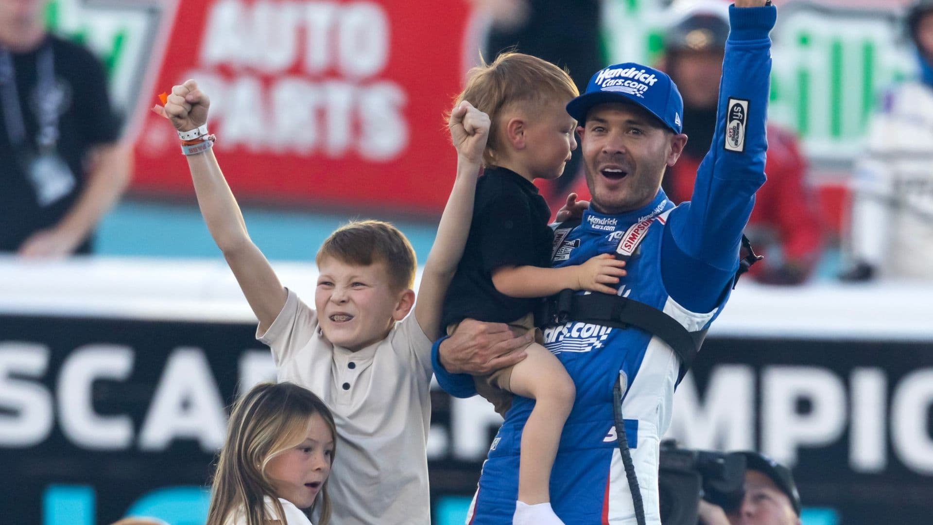 Nov 2, 2025; Avondale, Arizona, USA; NASCAR Cup Series driver Kyle Larson (5) celebrates with children Owen Larson, Audrey Larson and Cooper Larson after clinching the 2025 NASCAR Cup Series Championship following the NASCAR Championship race at Phoenix Raceway