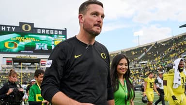 Oregon Ducks head coach Dan Lanning walks off the field with his wife, Sauphia, after a game against the Portland State Vikings at Autzen Stadium.