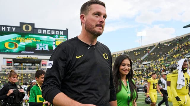 Oregon Ducks head coach Dan Lanning walks off the field with his wife, Sauphia, after a game against the Portland State Vikings at Autzen Stadium.