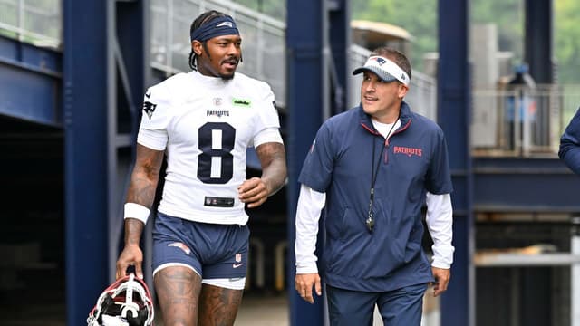 New England Patriots wide receiver Stefon Diggs (8) and offensive coordinator Josh McDaniels walk to the practice fields at Gillette Stadium.