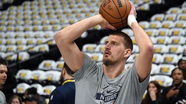 Dec 20, 2025; Denver, Colorado, USA; Denver Nuggets center Nikola Jokic (15) warms up before the game against the Houston Rockets at Ball Arena.