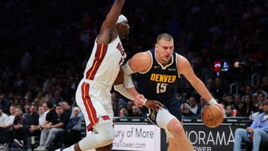 Denver Nuggets center Nikola Jokic (15) drives to the basket against Miami Heat center Bam Adebayo (13) during the second quarter at Kaseya Center.