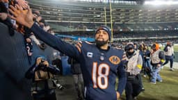 Chicago Bears quarterback Caleb Williams (18) high fives fans after defeating the Green Bay Packers during overtime at Soldier Field.