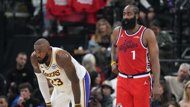 Los Angeles Lakers forward Lebron James (23) and LA Clippers guard James Harden (1) react in the first half at Intuit Dome.