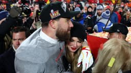 Recording artist Taylor Swift and Kansas City Chiefs tight end Travis Kelce (87) react after the AFC Championship game against the Buffalo Bills at GEHA Field at Arrowhead Stadium.