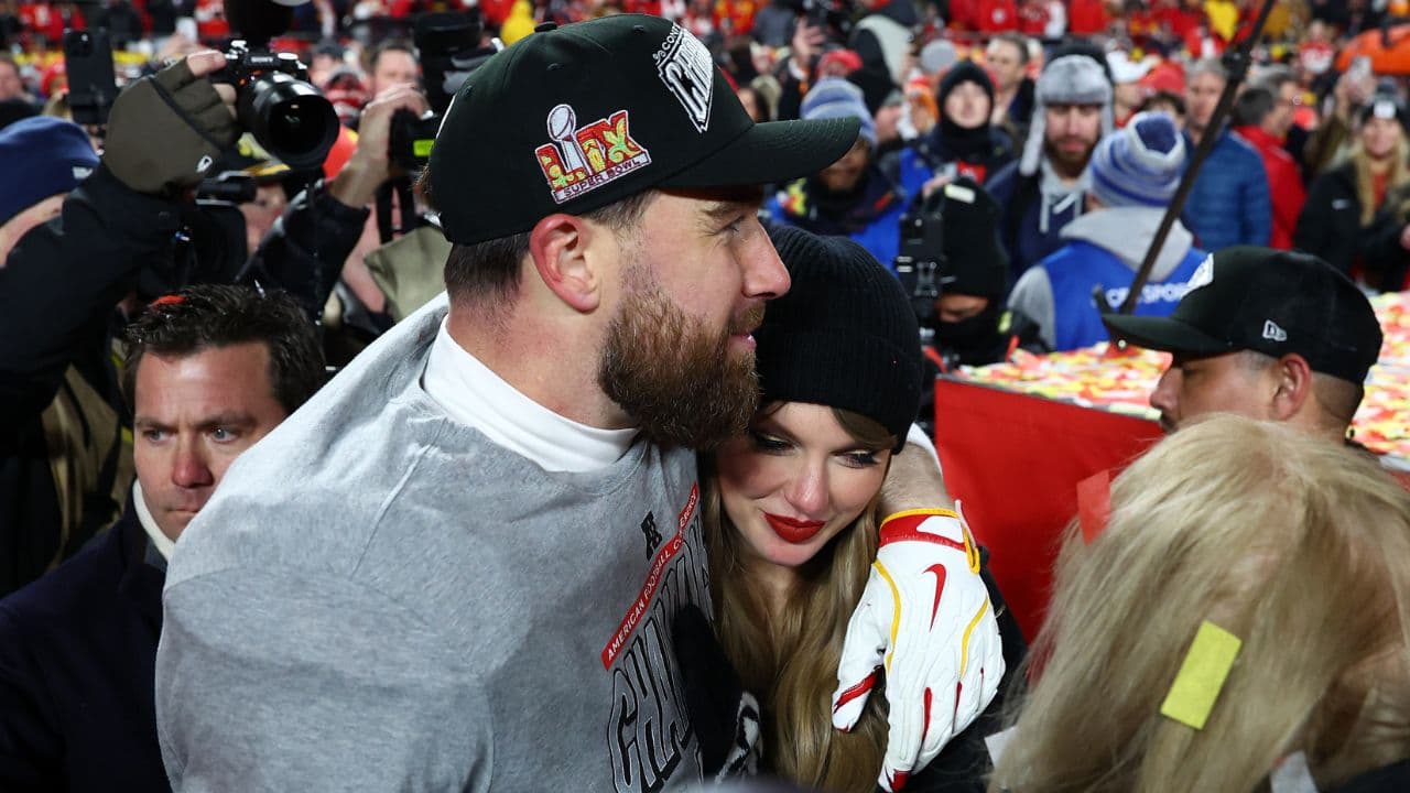 Recording artist Taylor Swift and Kansas City Chiefs tight end Travis Kelce (87) react after the AFC Championship game against the Buffalo Bills at GEHA Field at Arrowhead Stadium.