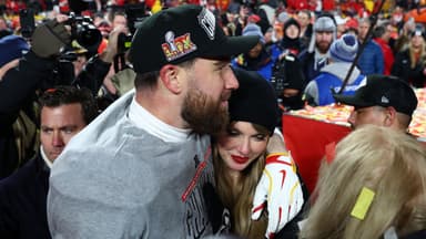 Recording artist Taylor Swift and Kansas City Chiefs tight end Travis Kelce (87) react after the AFC Championship game against the Buffalo Bills at GEHA Field at Arrowhead Stadium.