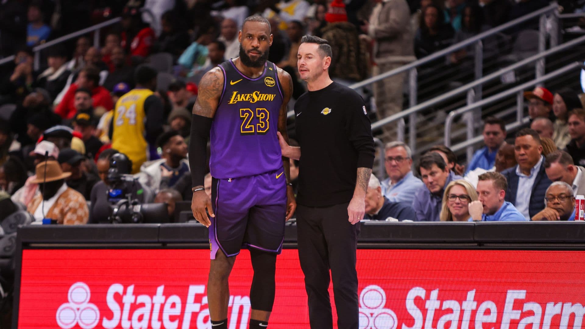 Dec 6, 2024; Atlanta, Georgia, USA; Los Angeles Lakers forward LeBron James (23) talks to head coach JJ Redick against the Atlanta Hawks in the second quarter at State Farm Arena