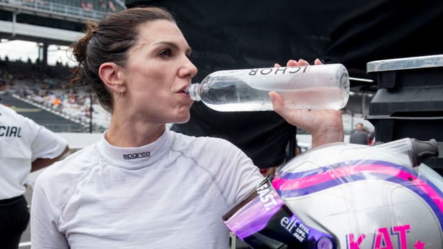 NASCAR Cup Series driver Katherine Legge (78) takes a sip of water Saturday, July 26, 2025, after her qualifying run for the Brickyard 400 at Indianapolis Motor Speedway.