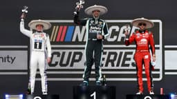 Shane Van Gisbergen celebrates on the podium after winning the NASCAR Cup Series Mexico alongside second place driver Christopher Bell and third place driver Chase Elliott during the NASCAR Cup Series Mexico City Race at Autodromo Hermanos Rodriguez.