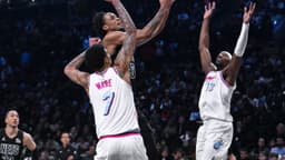Brooklyn Nets center Nic Claxton (33) drives to the basket against Miami Heat center Kel'el Ware (7) and center Bam Adebayo (13) during the second half at Barclays Center