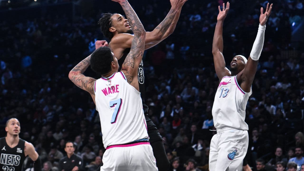 Brooklyn Nets center Nic Claxton (33) drives to the basket against Miami Heat center Kel'el Ware (7) and center Bam Adebayo (13) during the second half at Barclays Center