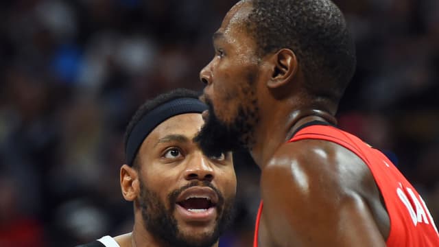 Dec 20, 2025; Denver, Colorado, USA; Denver Nuggets guard Bruce Brown (11) talks with Houston Rockets forward Kevin Durant (7) after a defensive stop during the second half at Ball Arena.