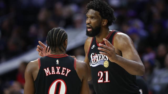 Philadelphia 76ers center Joel Embiid (21) talks with guard Tyrese Maxey during the second quarter against the Los Angeles Lakers at Xfinity Mobile Arena.