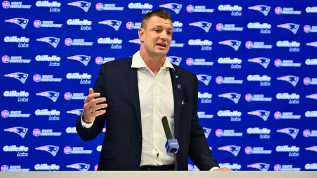 New England Patriots former player and current Fox Sports football analyst Rob Gronkowski speaks during a press conference where he signed a ceremonial one day contract at Gillette Stadium.