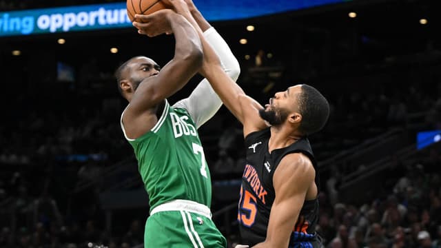 Dec 2, 2025; Boston, Massachusetts, USA; Boston Celtics guard Jaylen Brown (7) attempts a basket past New York Knicks guard Mikal Bridges (25) during the second half at the TD Garden.